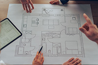 Homeowners consulting on a floorplan with custom home builders in NJ