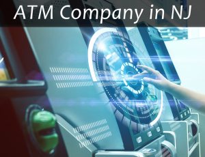 ATM Company in NJ in white text over diluted black bar on close-up picture of 3 ATMs with middle one shown with a hand with finger extended using screen