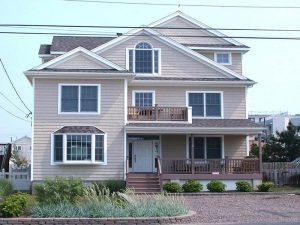 Seaside Park rentals like this one shown (tan siding, white trim, porch, small deck on level 2, mulit-level) are in demand