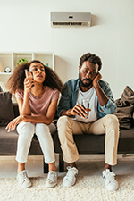 Couple suffering in the heat from ignoring air conditioner repair in Mantoloking