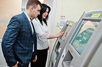 ATM company in NJ employee training a branch employee on a new ATM